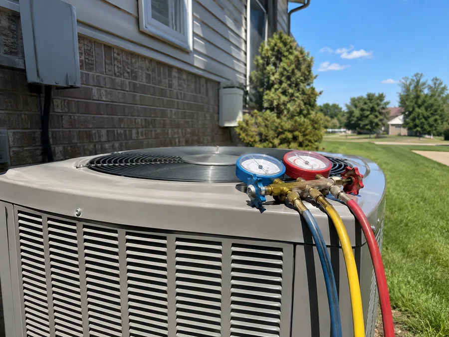 Refrigerant gauges connected to a central air conditioner during an AC repair diagnostic near Norwich, Ontario